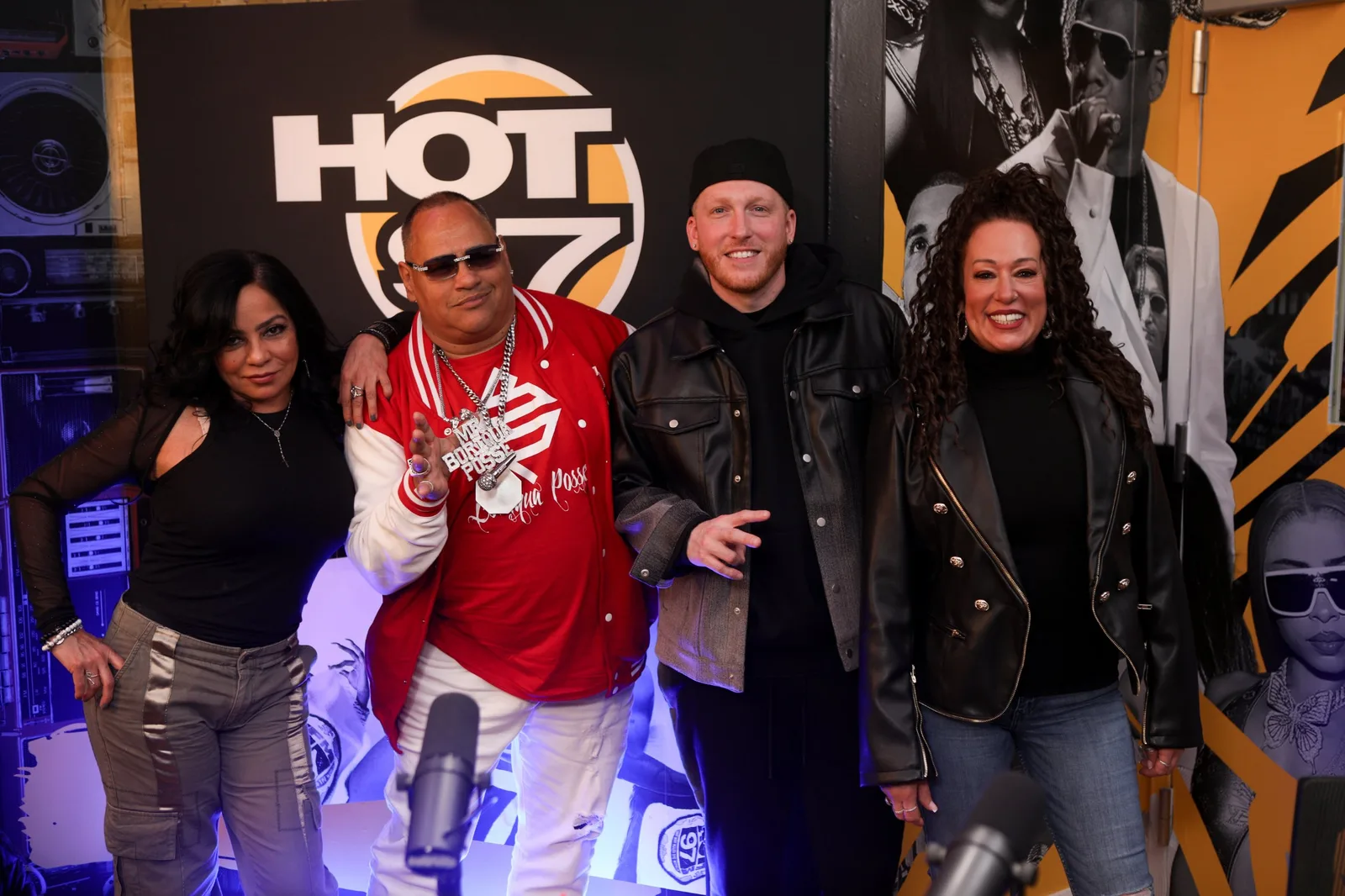 Group photographed in the Hot 97 radio studio