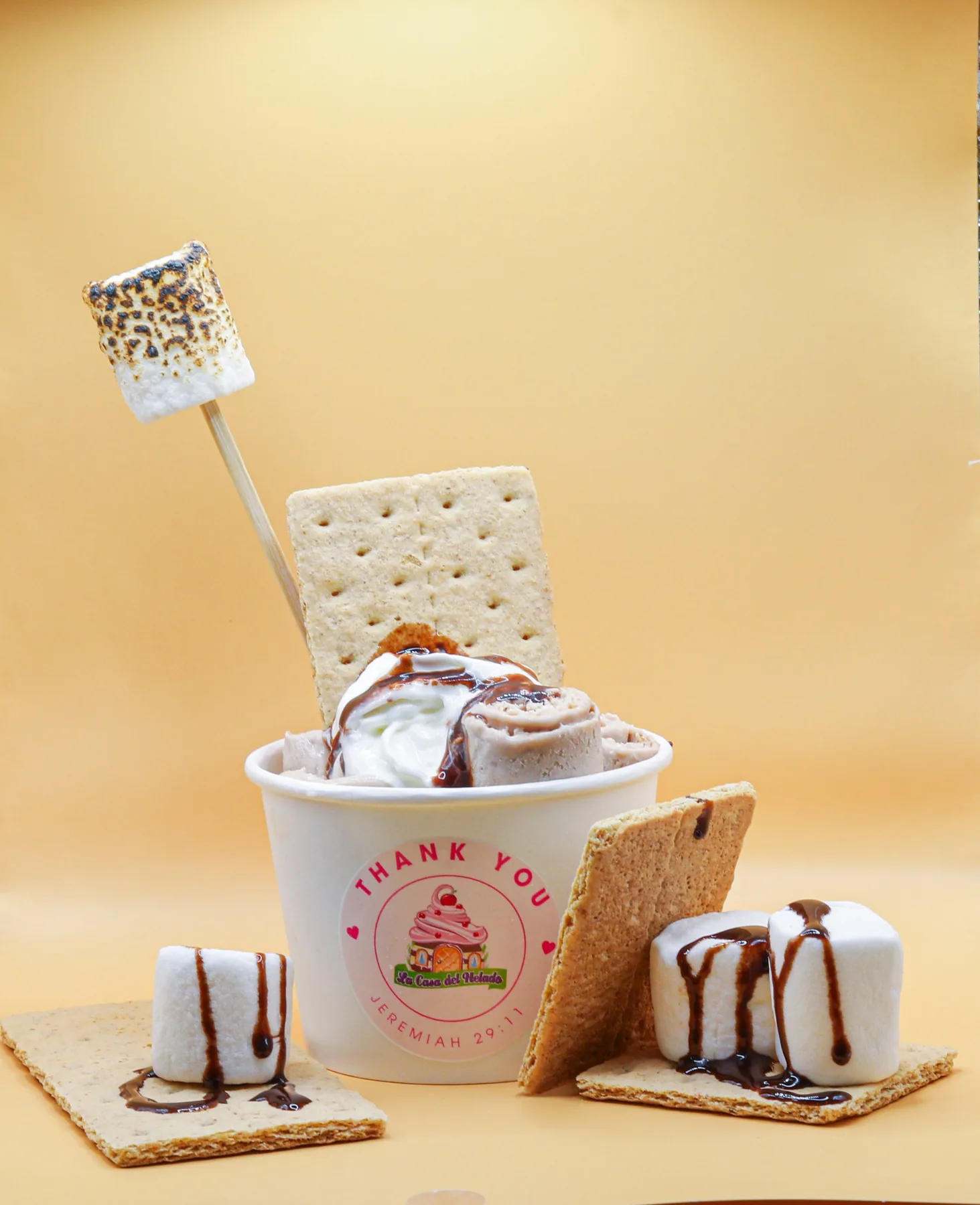 S'mores rolled ice cream with toasted marshmallows, styled product shot for an ice cream shop